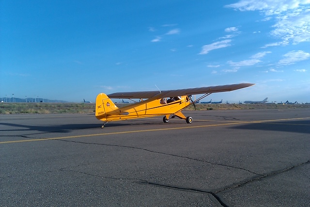 J.P. Barelli's yellow Piper Cub on a runway